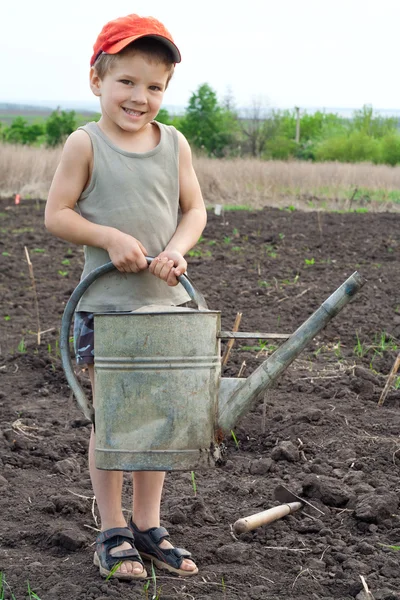 Little boy with old watering can — Stock Photo, Image