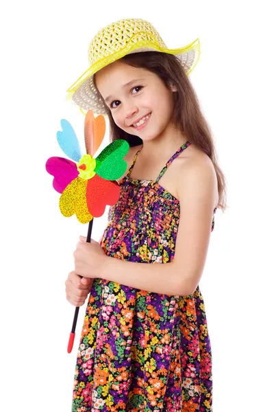 Menina sorridente com moinho de vento colorido — Fotografia de Stock