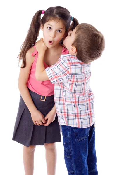 Little boy whispering something to girl — Stock Photo, Image