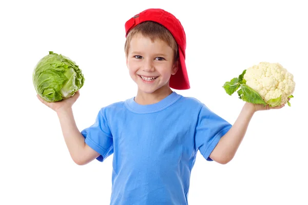 Smiling kid with cabbage and cauliflower — Stock Photo, Image