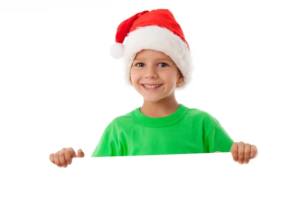 Menino de Natal de pé com branco vazio — Fotografia de Stock