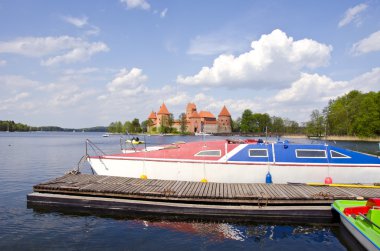 Historical Trakai castle and boats on the lake clipart