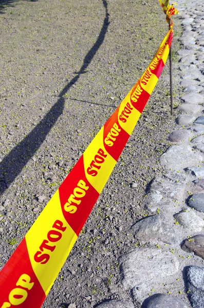 Warning tape stop on the road — 스톡 사진