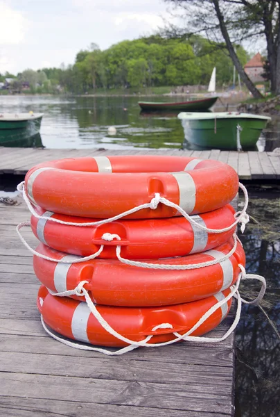 Group red life buoy on lake bridge — Stock Photo, Image