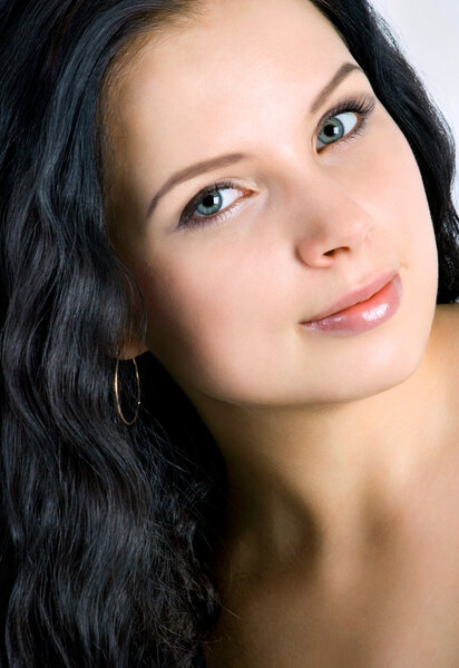 Beautiful young woman face. Black hair. Close up