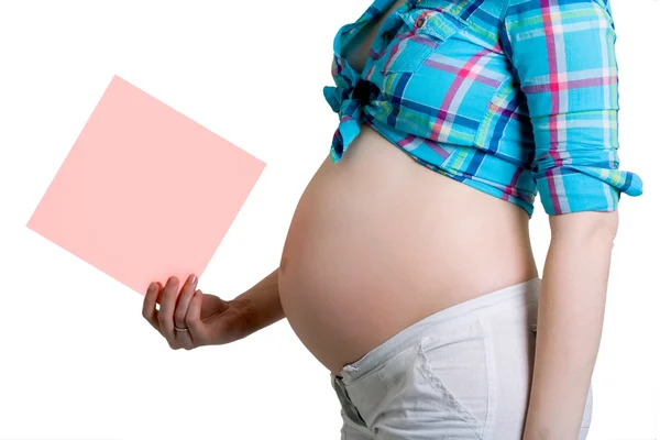 Pregnant beautiful young woman with blank post-it note. All on w — Stock Photo, Image