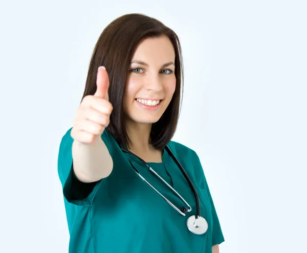Smiling medical female doctor showing thumbs up gesture isolated — Stock Photo, Image