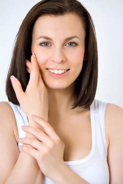 Young woman holding her hands against her face — Stock Photo, Image