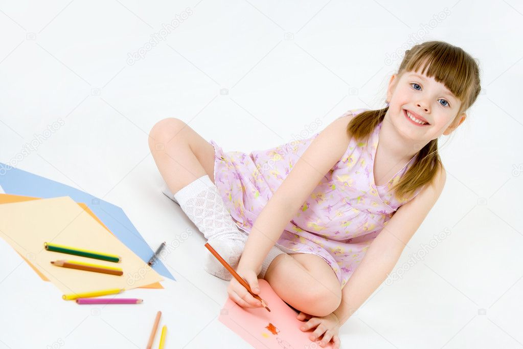 Cute child draw with colorful crayons and smile, isolated over w
