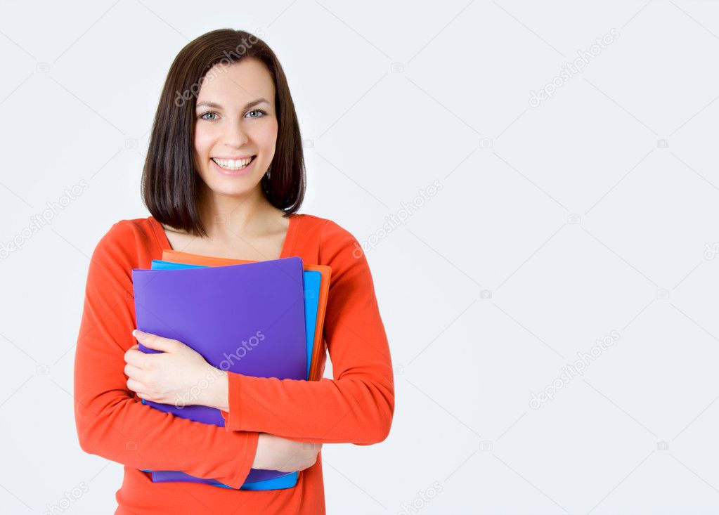 Young smiling student woman. Over gray background