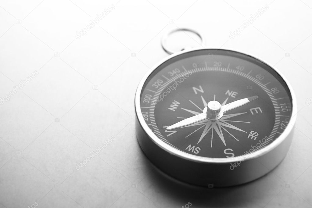Compass on a gray gradient background, place for text