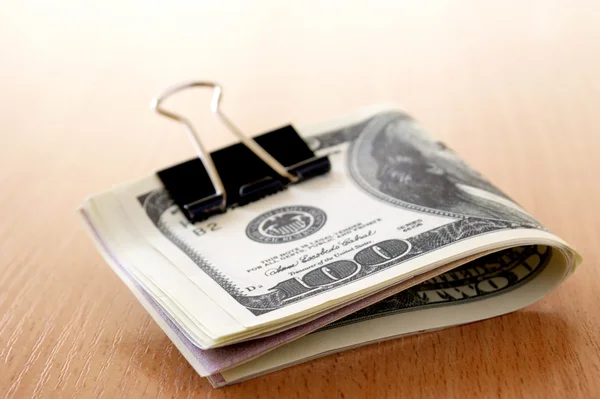 Dollar på ett träbord och oskärpa bakgrunden — Stockfoto