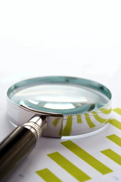 Chart and a magnifying glass — Stock Photo, Image
