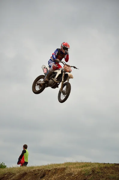 Motocross rider in flight removes the protective film from the g — Stock Photo, Image