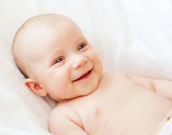 Laughing baby on white towel — Stock Photo, Image