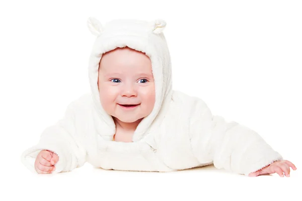 Bambino sorridente sdraiato sul pavimento bianco Foto Stock Royalty Free