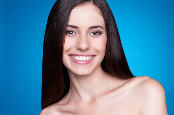 Menina sorridente sobre fundo azul — Fotografia de Stock