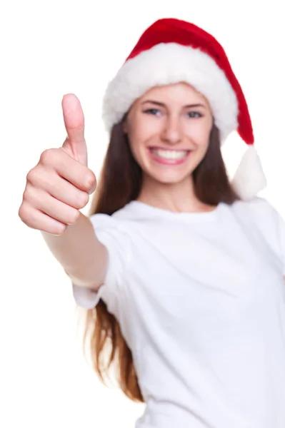 Mädchen mit Weihnachtsmütze zeigt Daumen hoch — Stockfoto