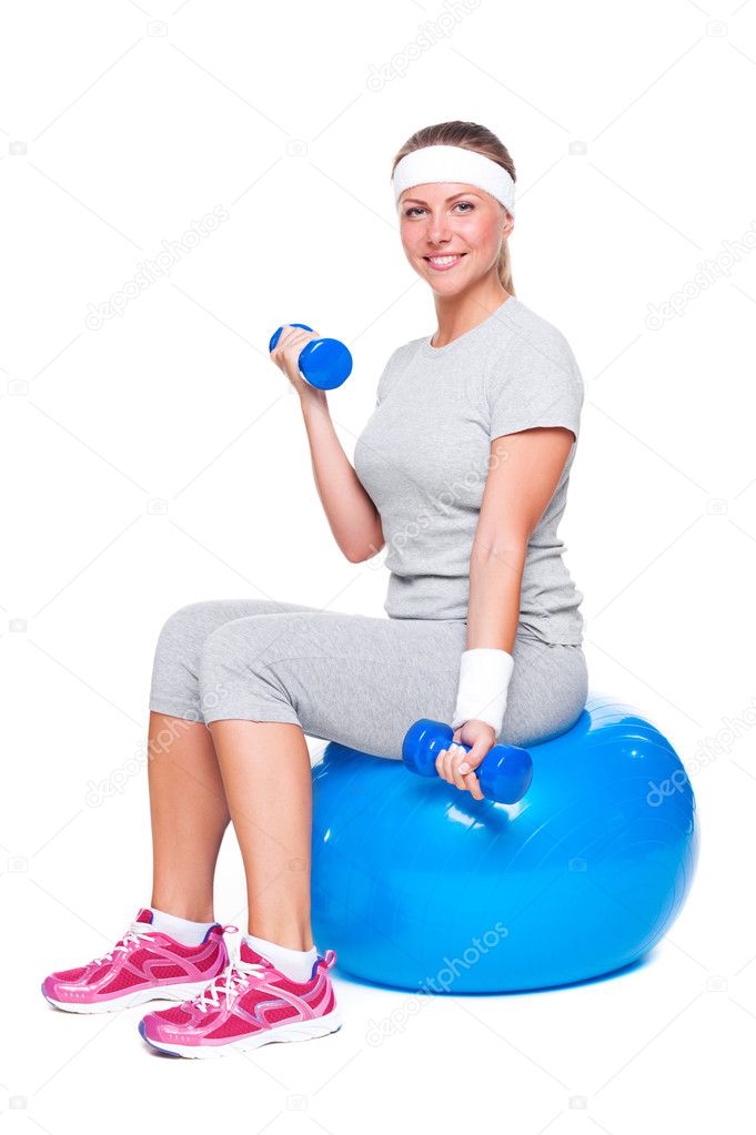 Attractive sportswoman doing exercise for biceps