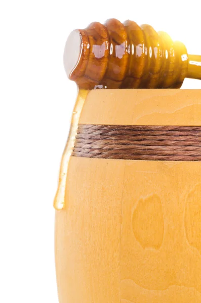 Barril de mel com uma colher deitada sobre ele — Fotografia de Stock