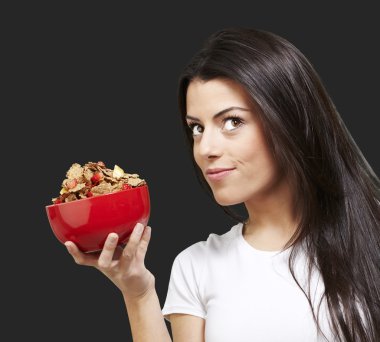 Woman holding a bowl with cereals clipart