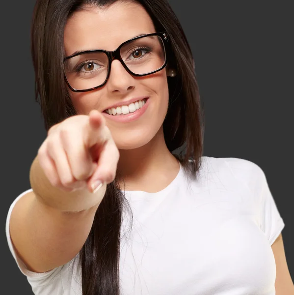 Porträtt av ung kvinna som pekar med finger mot en svart bac — Stockfoto
