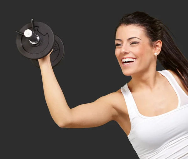 Porträtt av ung flicka träning med vikter över svart ba — Stockfoto