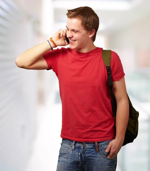 Portret młodzieńca rozmowy na telefon komórkowy w nowoczesnym budynku — Zdjęcie stockowe