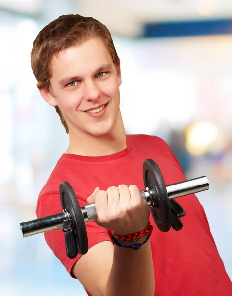 Portrait of young man with weights in indoor — Stock Photo, Image