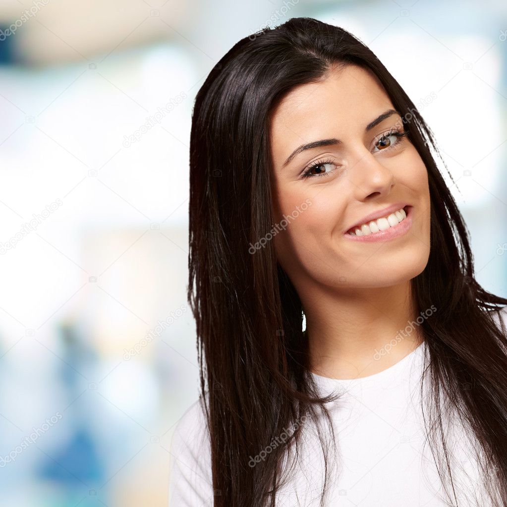 Portrait of pretty young woman smiling indoor