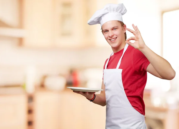 Portrait of young cook man at kitchen — Stock Photo, Image