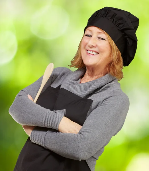 Porträtt av kvinna koka bär förkläde mot naturen bakgrund — Stockfoto