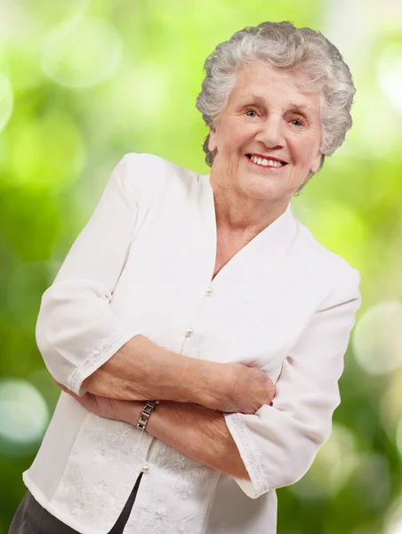 Porträt einer entzückenden Seniorin, die vor einem Naturpark steht. — Stockfoto
