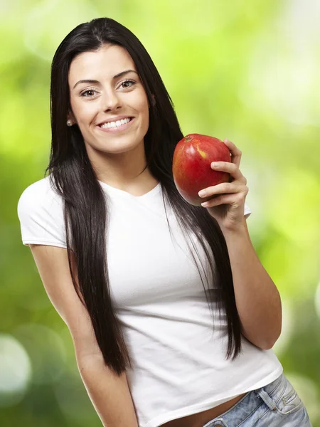 Woman holding a mango — Stock Photo, Image