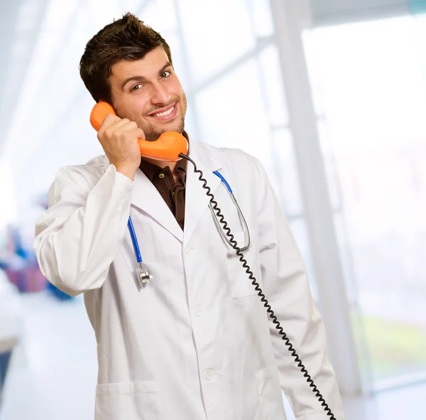 Красивый доктор разговаривает по телефону — стоковое фото