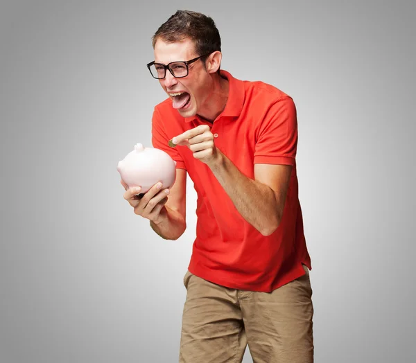 Portrait Of Man With Piggy Bank Inserting A Coin — Stock Photo, Image