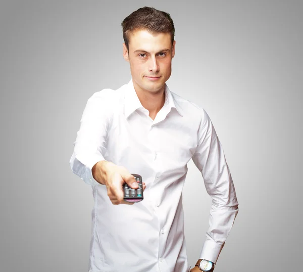 Man Holding Remote In His Hand — Stock Photo, Image