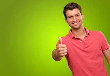 Young man smiling with thumbs up clipart