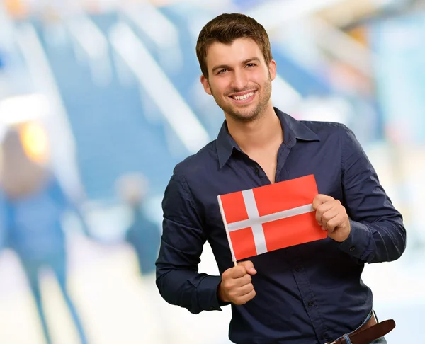 Potrait of a young man holding flag — Stock Photo, Image