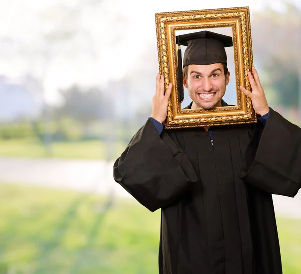 stock image Graduate man looking through a frame