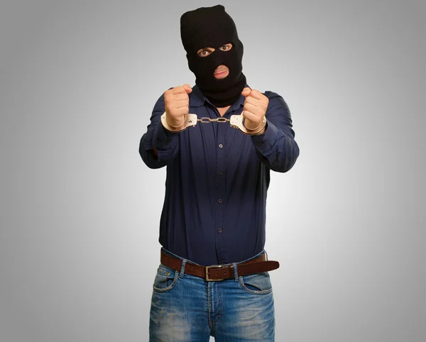 Angry criminal man locked in handcuffs — Stock Photo, Image