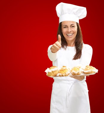 Woman chef holding baked food clipart