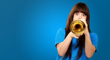 Portrait of a teenager playing trumpet clipart