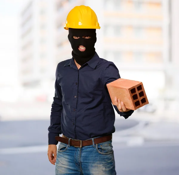 stock image Angry criminal man with brick