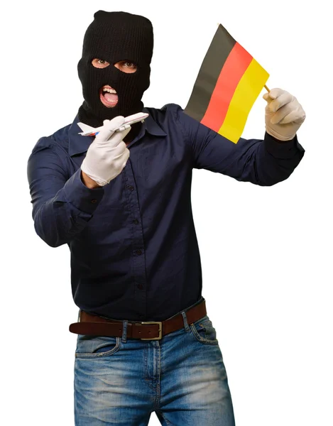 En mann med en røvermaske, med miniatyr og fla. – stockfoto