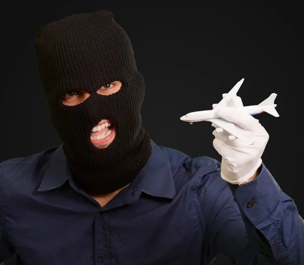 Man dragen Rover masker en bedrijf vliegtuig miniatuur — Stockfoto
