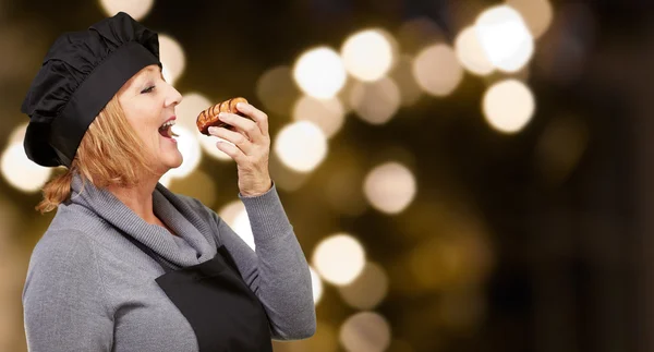 Портрет жінки під час їжі тісто — стокове фото