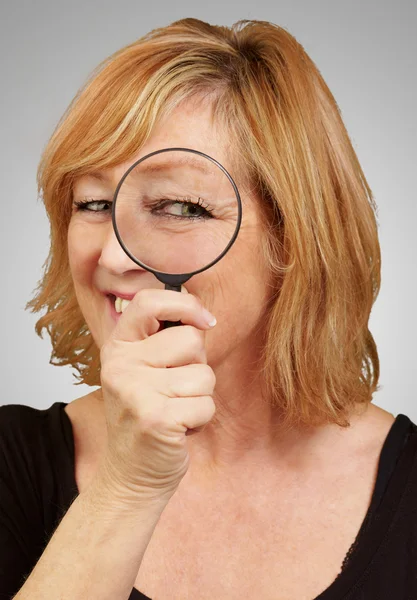 Vrouw met behulp van een vergrootglas — Stockfoto