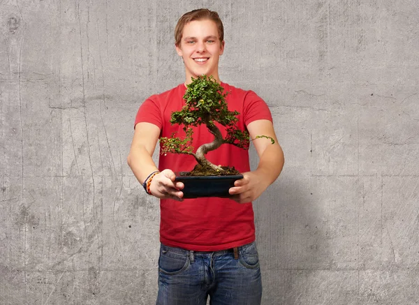 Portrait of a young man holding a pot — Stock Photo, Image