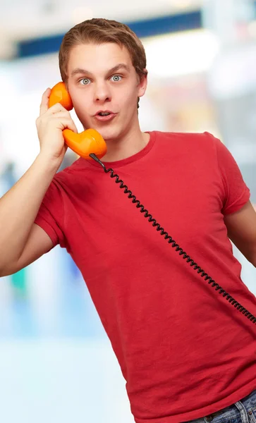 Portrait of a young man talking on vintage phone — Stock Photo, Image